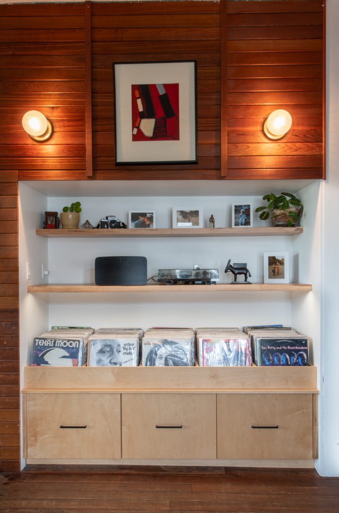 Maple record cabinet with storage and floating shelves.
