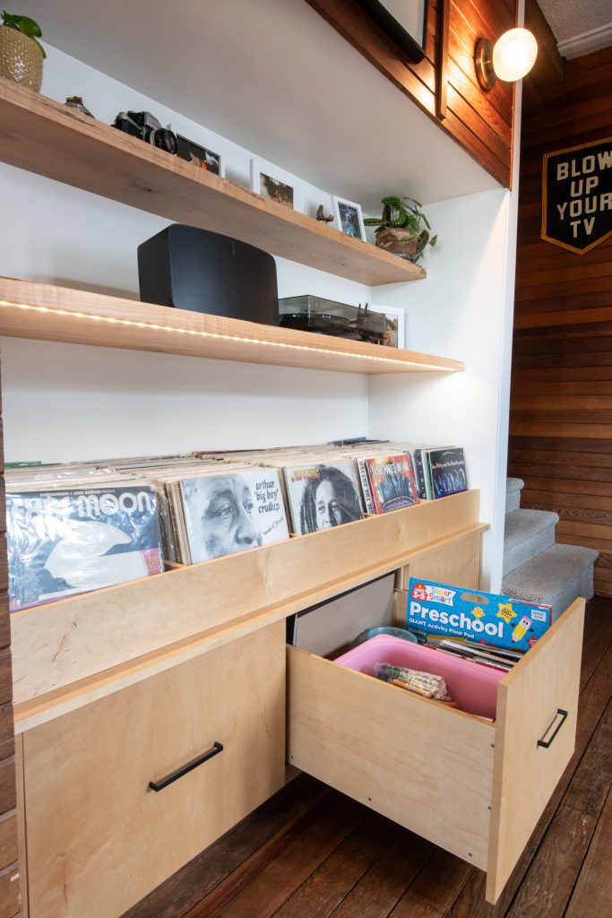 Maple record cabinet with storage and floating shelves.
